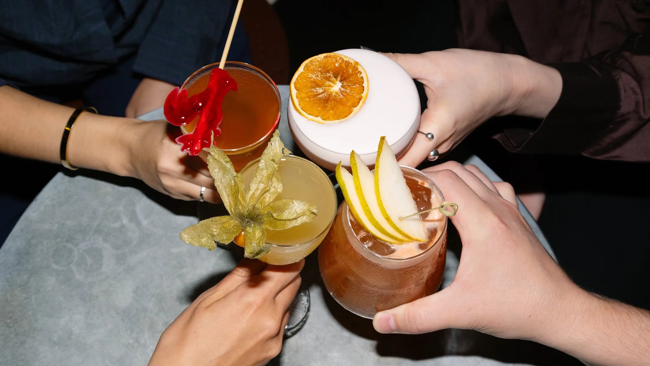 Guests raising glasses across a table at ZIMA