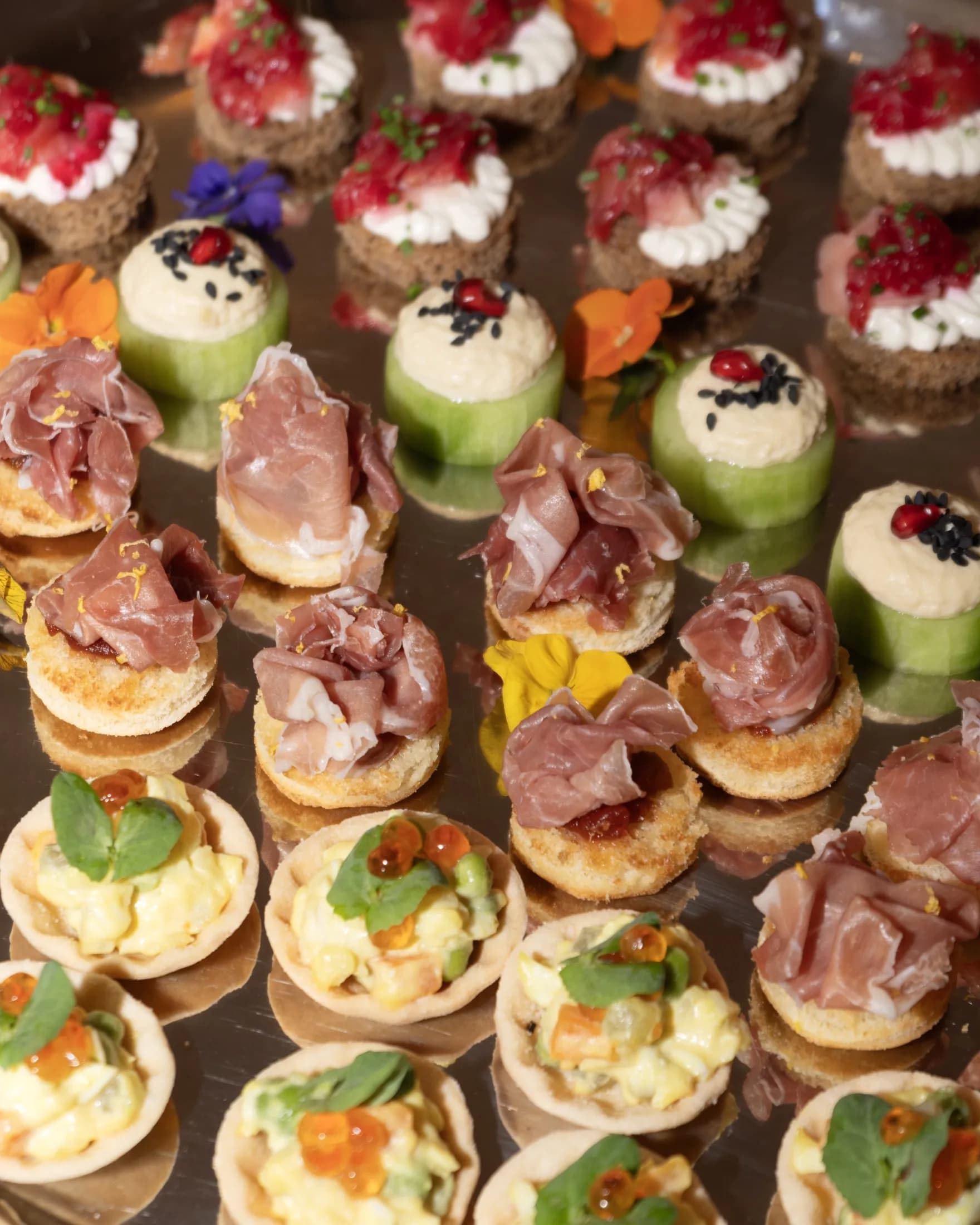 Assorted ZIMA canapés on a silver tray