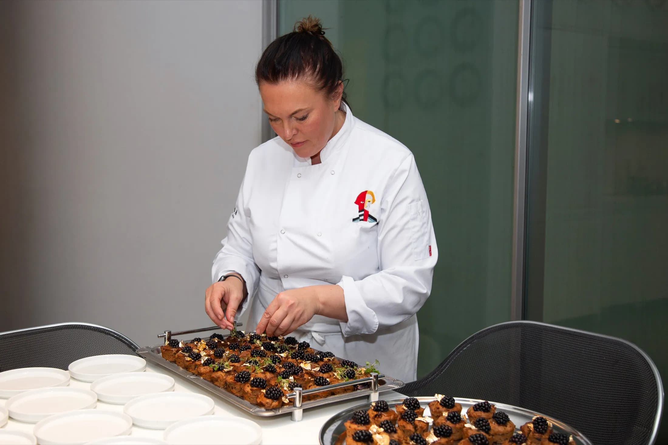 A ZIMA chef finishing trays before service