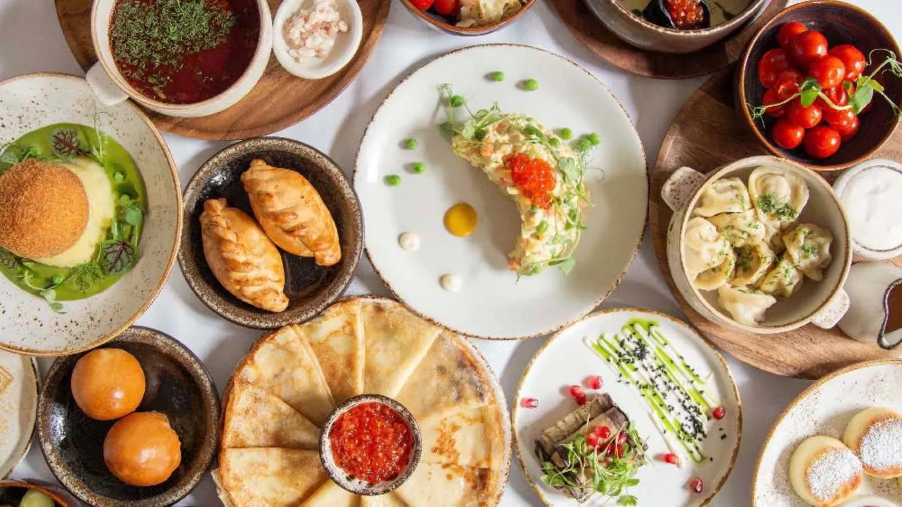 Feast spread of Slavic dishes at ZIMA